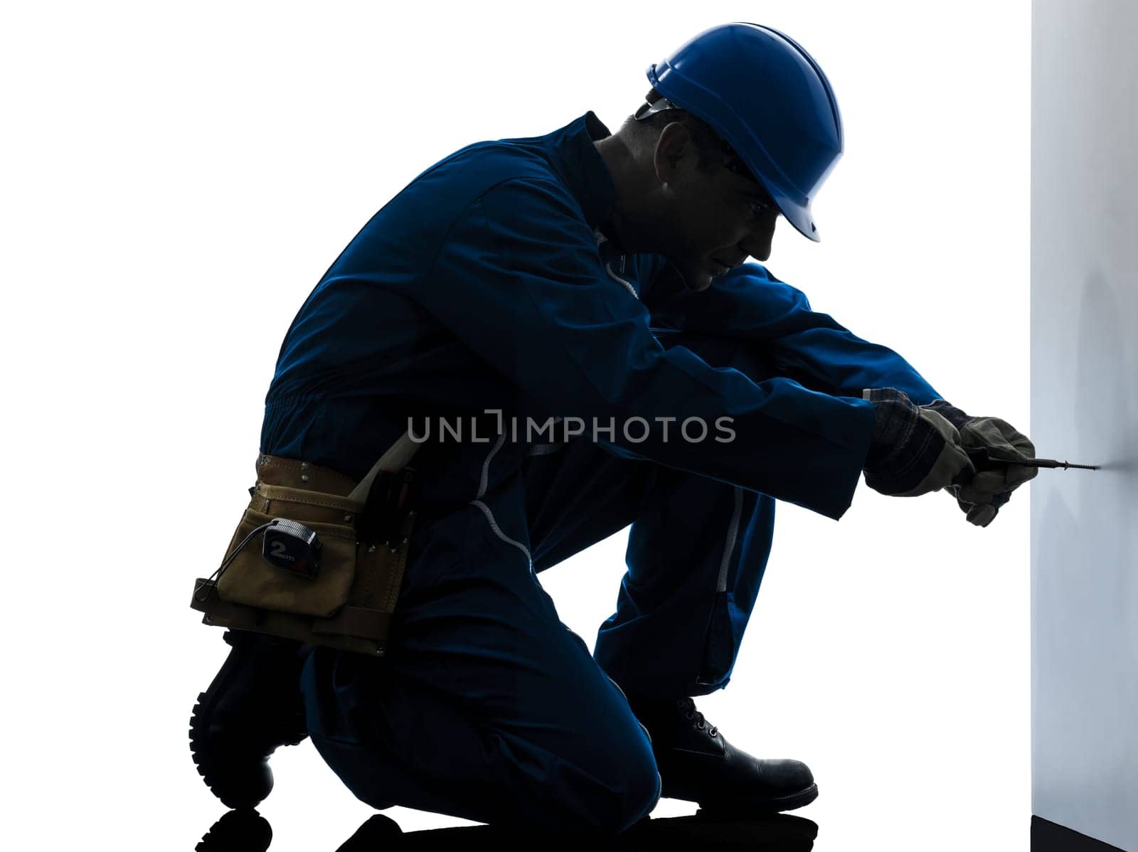 one caucasian man construction worker screwdriving silhouette in studio on white background