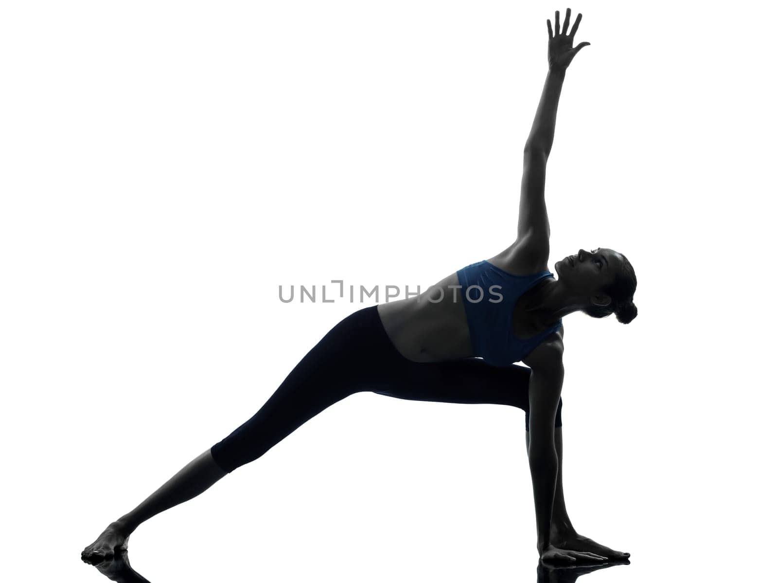 one caucasian woman exercising stretching triangle pose yoga in silhouette studio isolated on white background