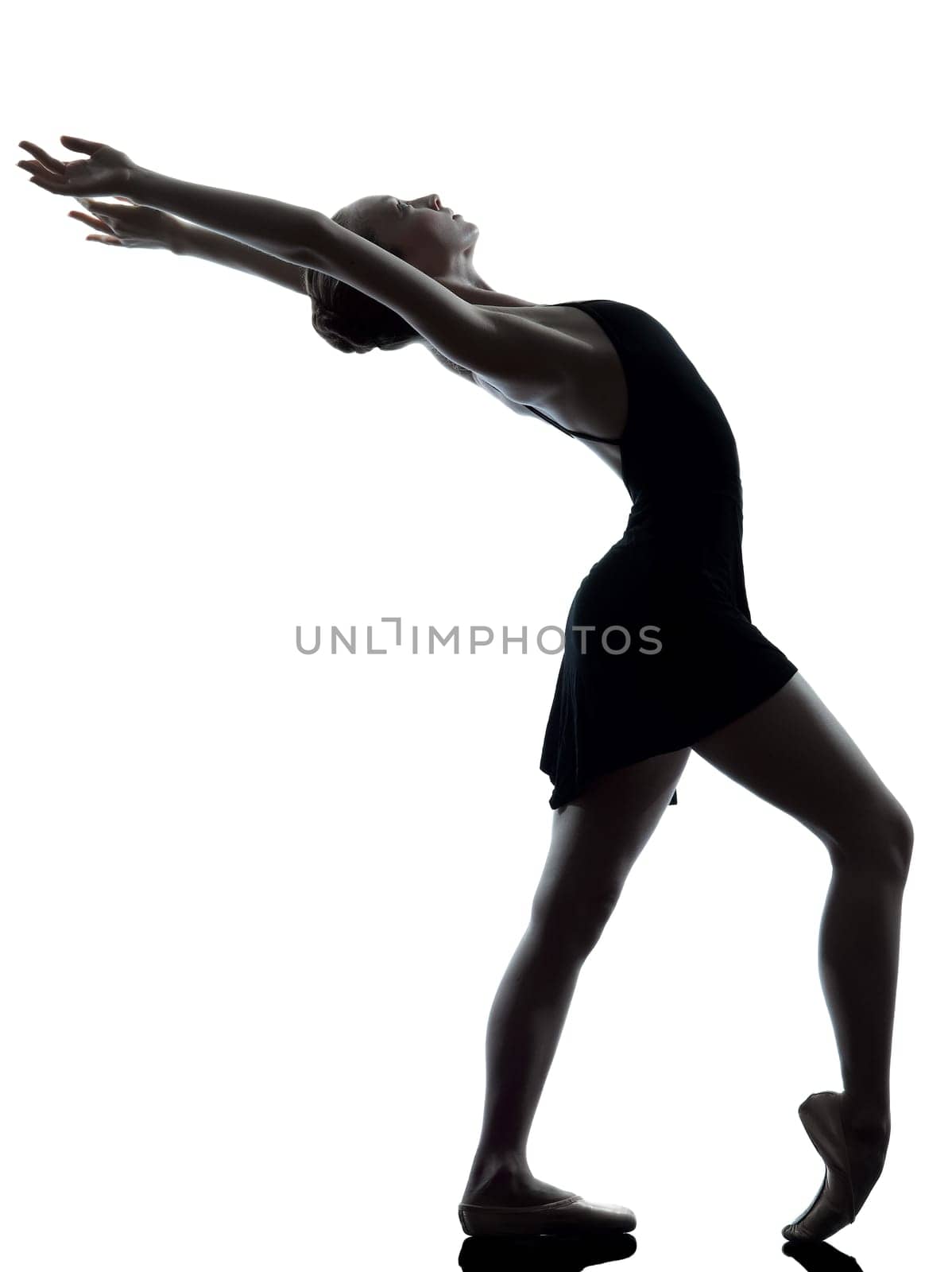 one caucasian young woman ballerina ballet dancer stretching warming up in silhouette studio on white background
