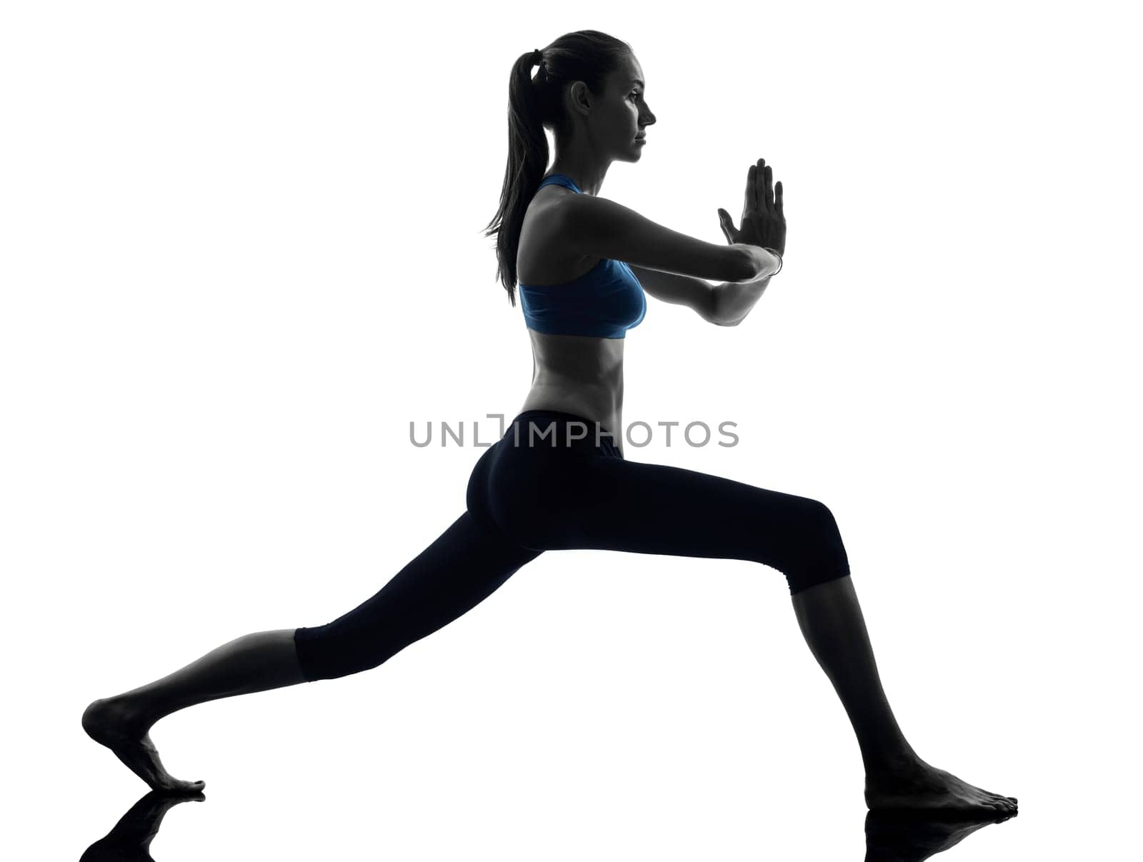 one caucasian woman exercising yoga warrior position in silhouette studio isolated on white background