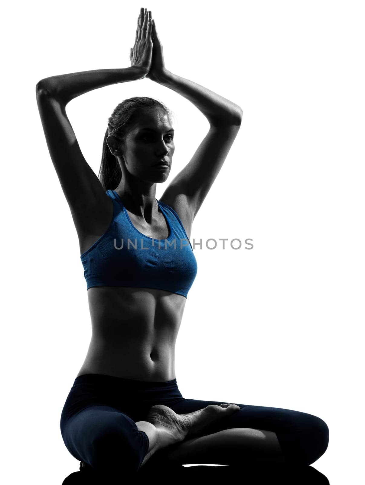 one caucasian woman exercising yoga meditating sitting hands joined in silhouette studio isolated on white background