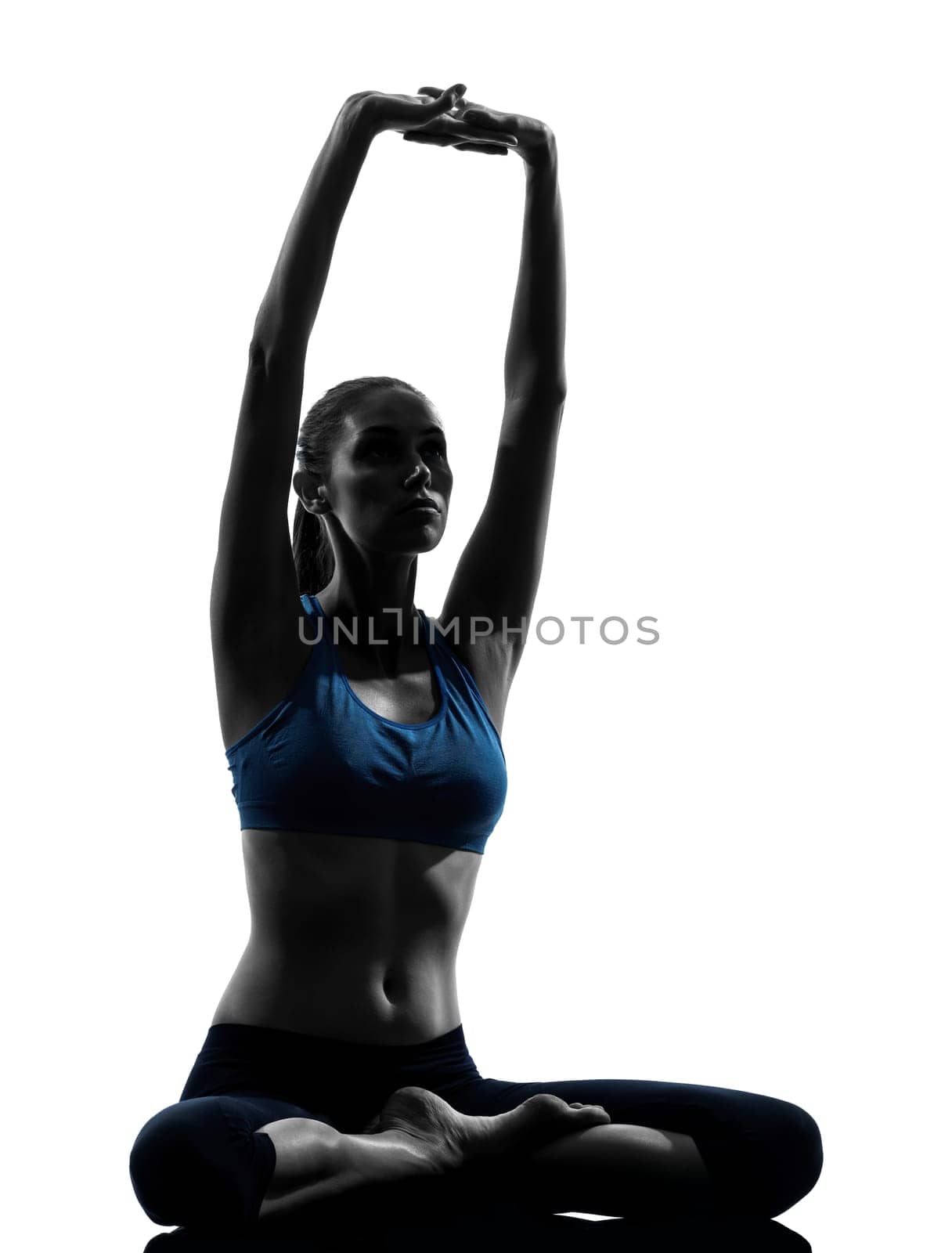 one caucasian woman exercising yoga meditating sitting stretching in silhouette studio isolated on white background