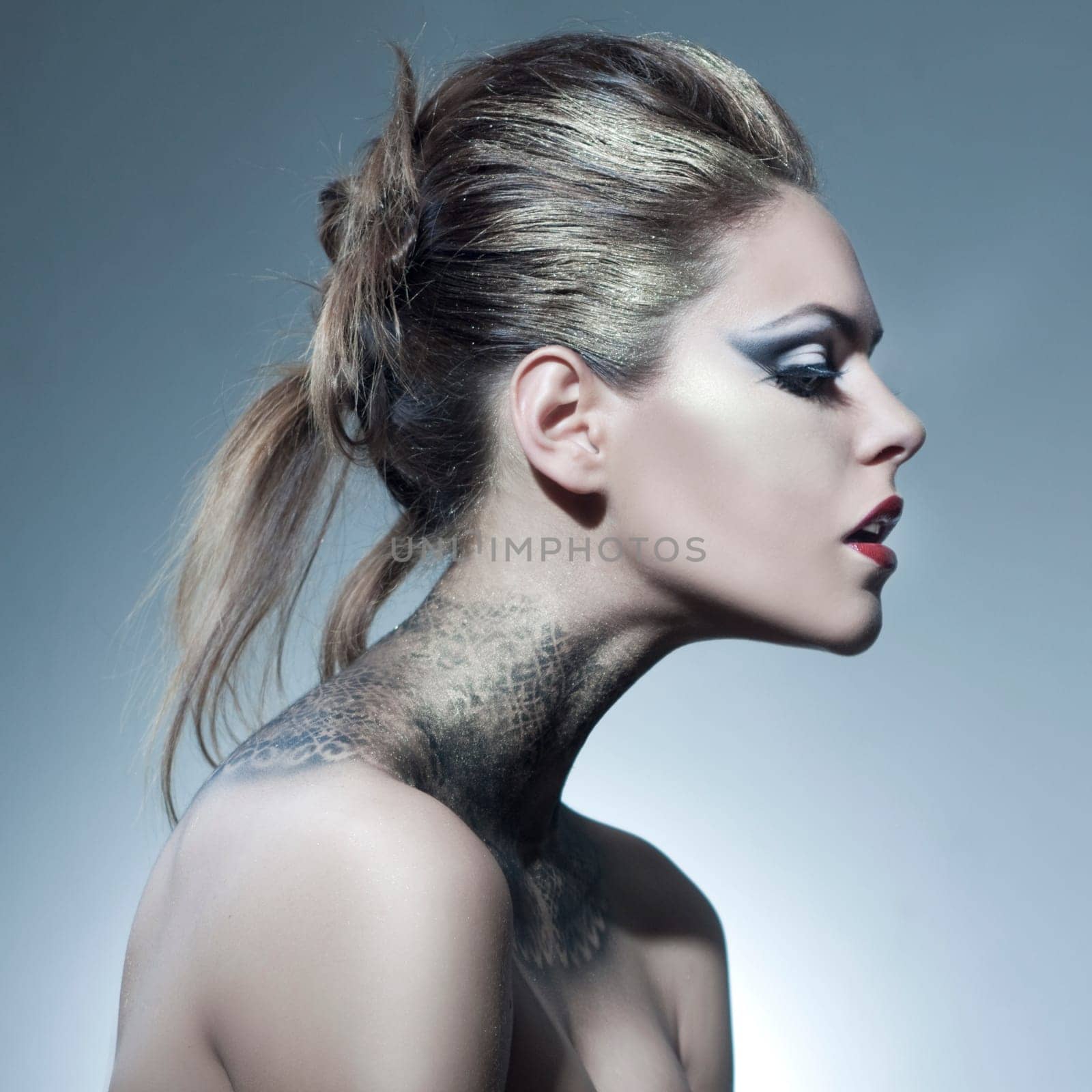 Beautiful young woman with exciting makeup and beautiful hairstyling