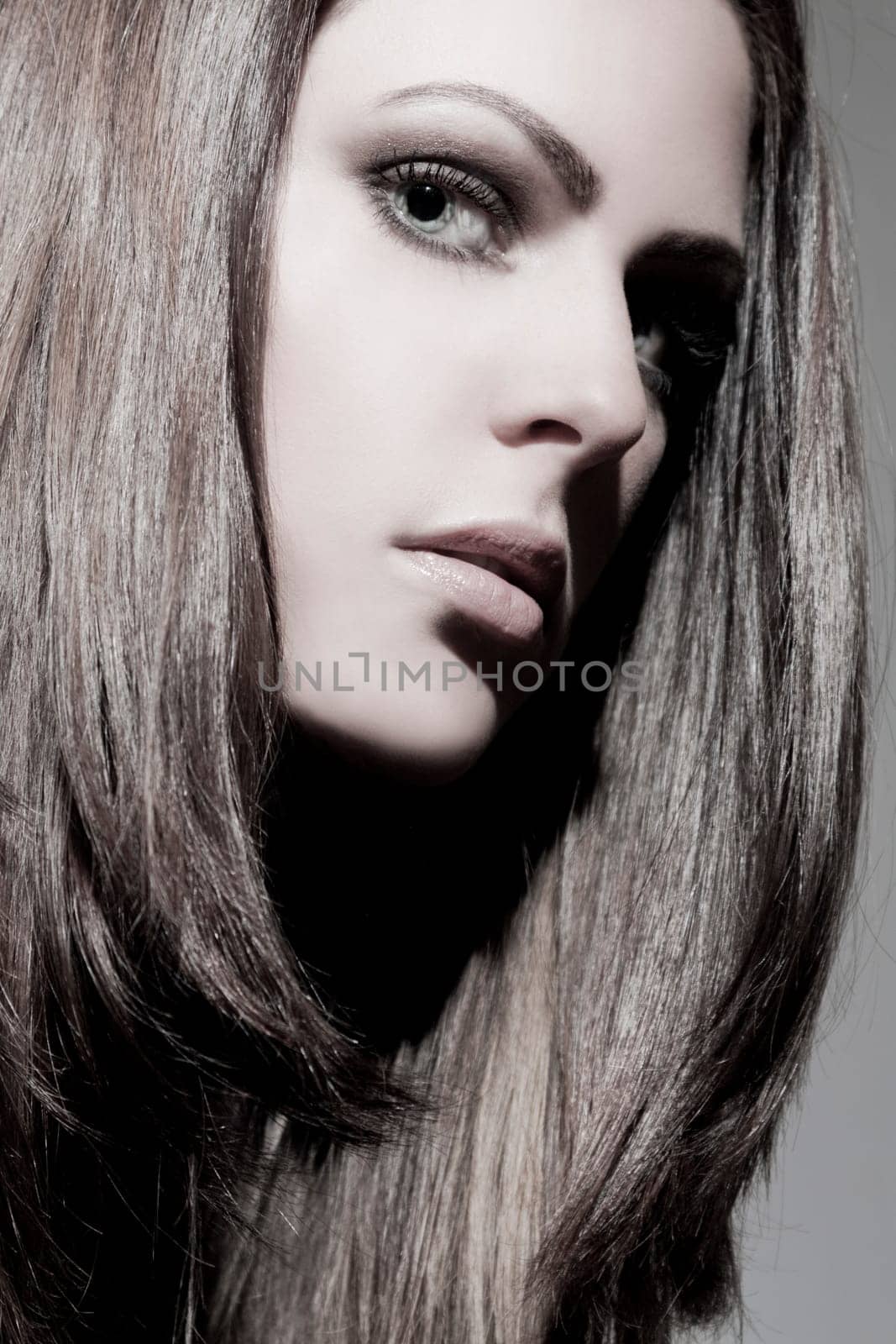 Beautiful young woman with shiny,healthy hair and perfect makeup