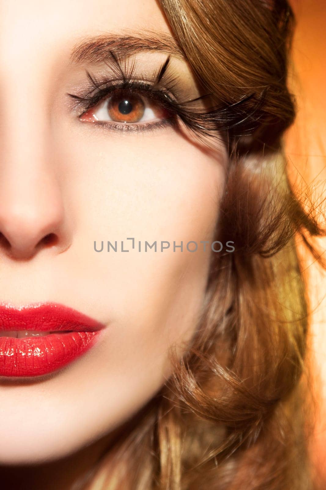 Beautiful young woman with long eyelashes and healthy hair
