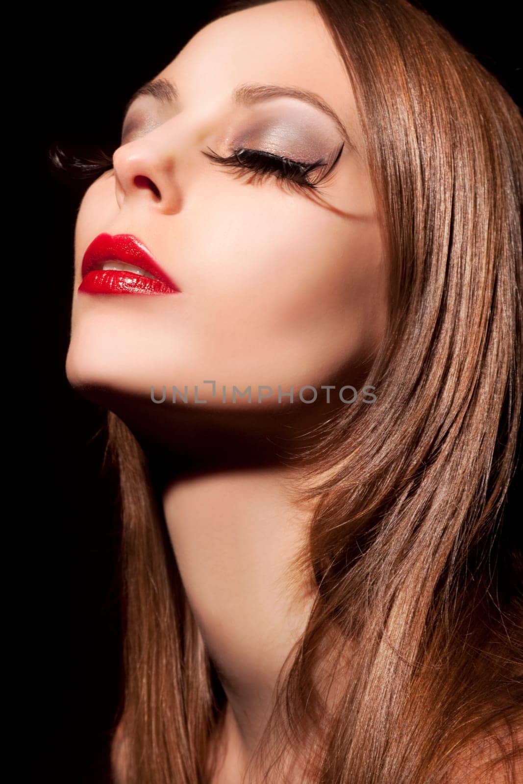 Beautiful young woman with long eyelashes and healthy hair