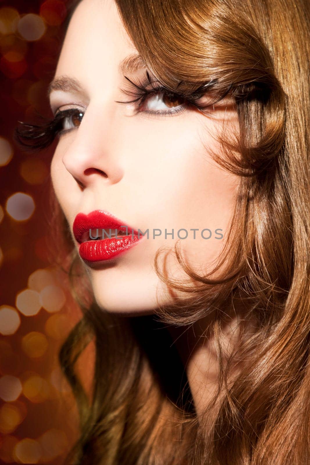 Beautiful young woman with long eyelashes and healthy hair