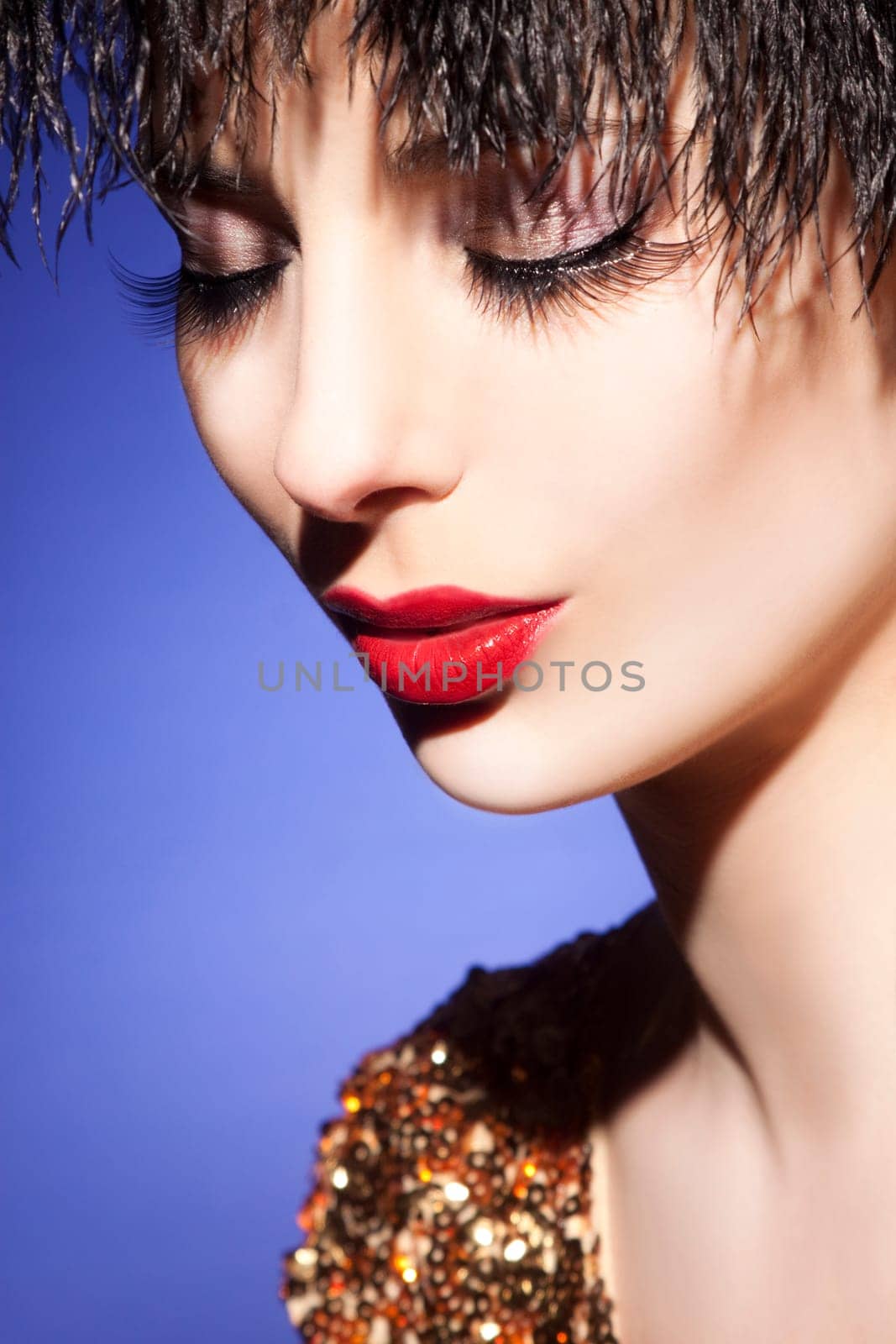 Beautiful young woman with perfect makeup and long eyelashes