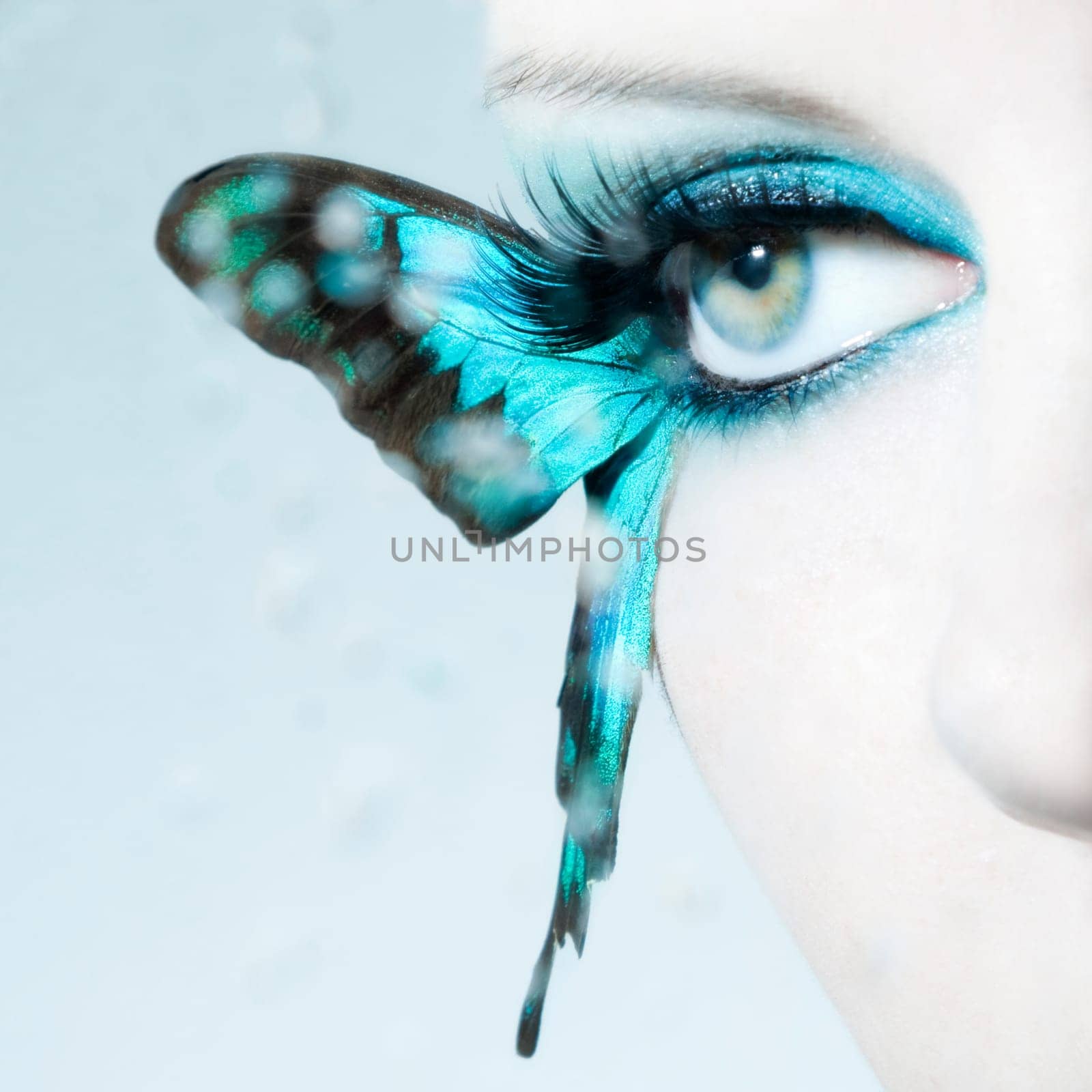 Eye of a young woman with butterfly wings