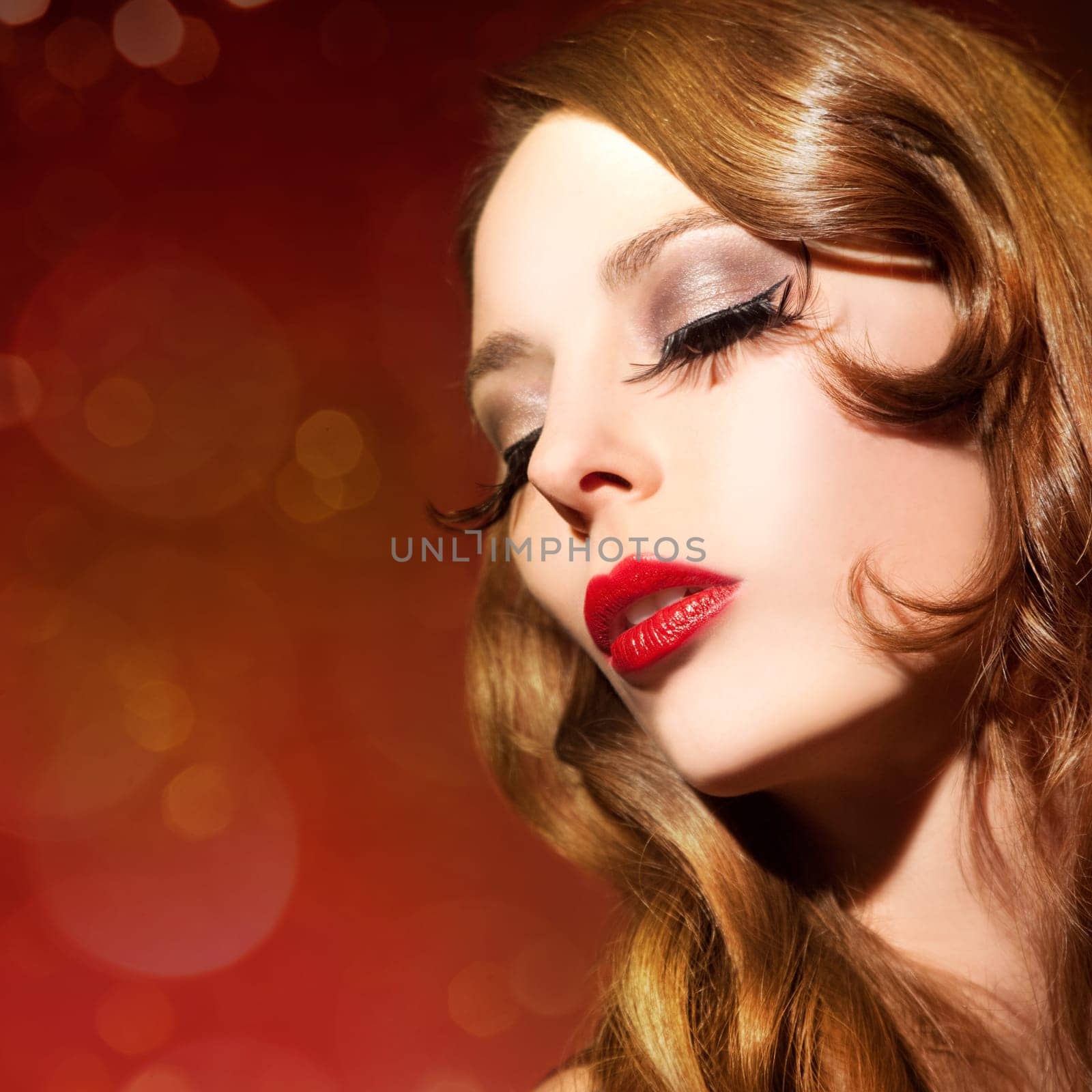 Beautiful young woman with long eyelashes and healthy hair