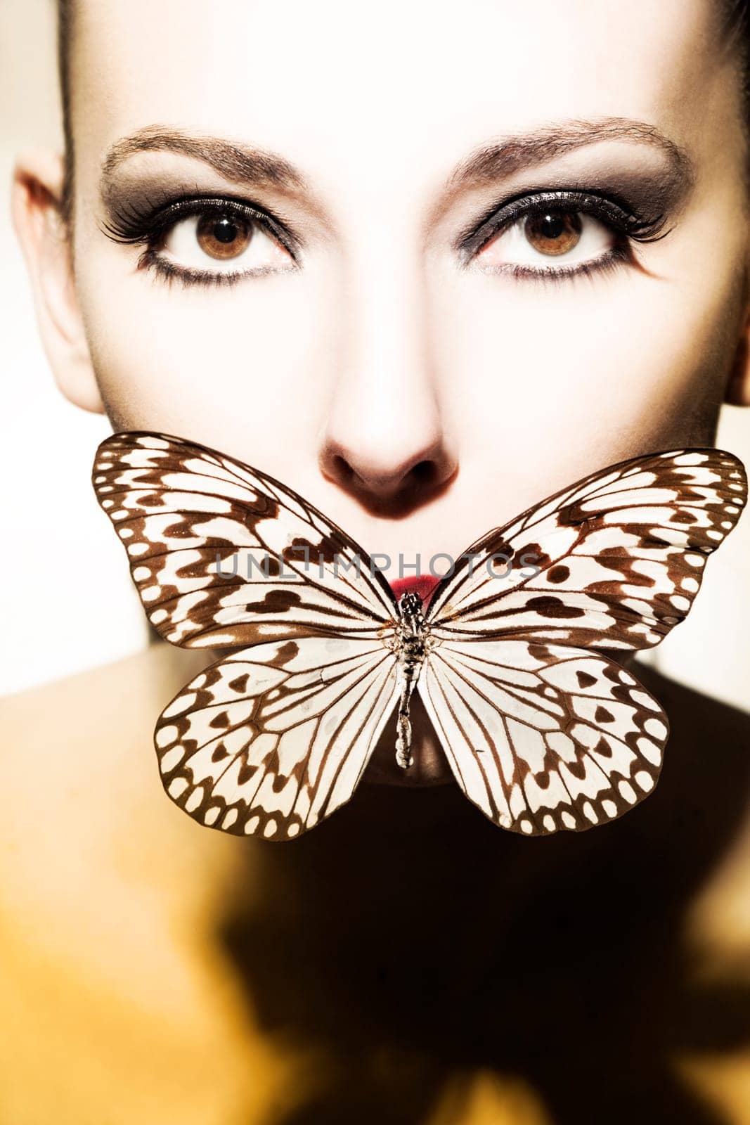 Face of a beautiful,young woman with butterfly