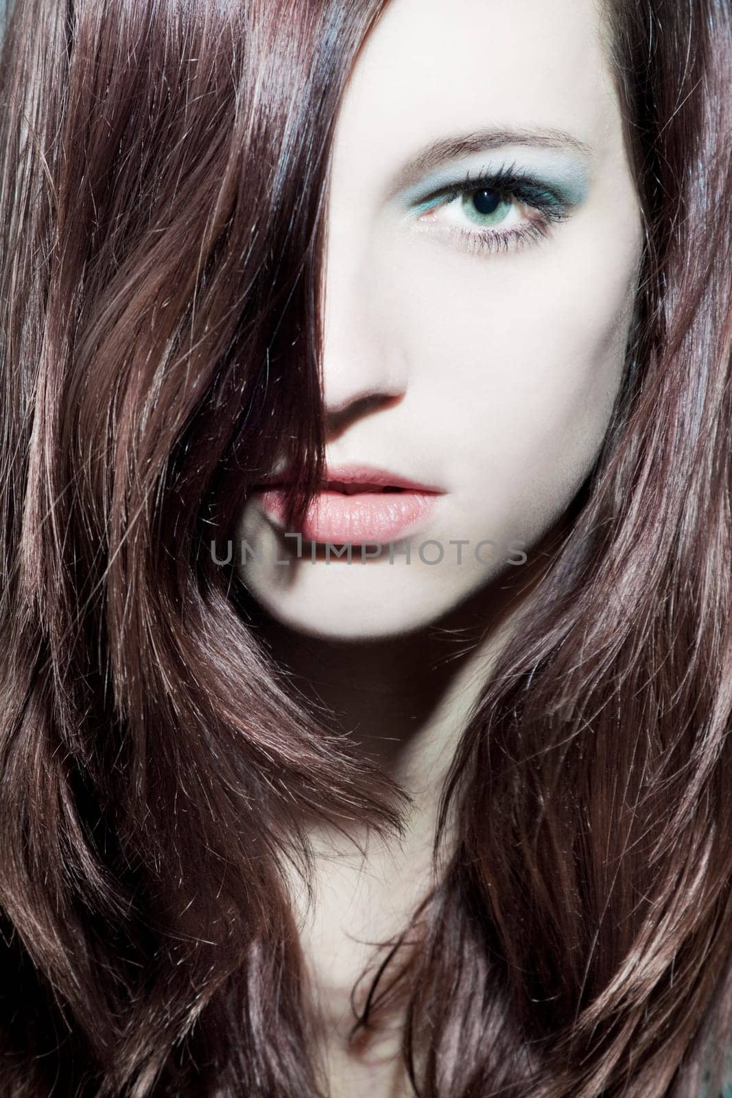 Beautiful young woman with healthy,shiny hair and makeup