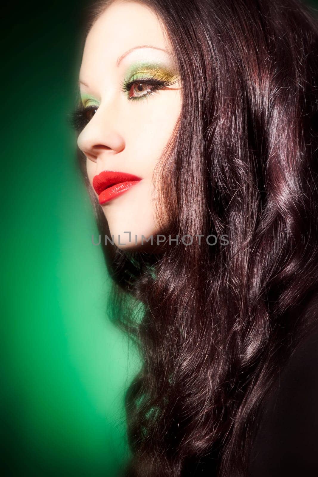 Beautiful young woman with red lipstick and long curly hair