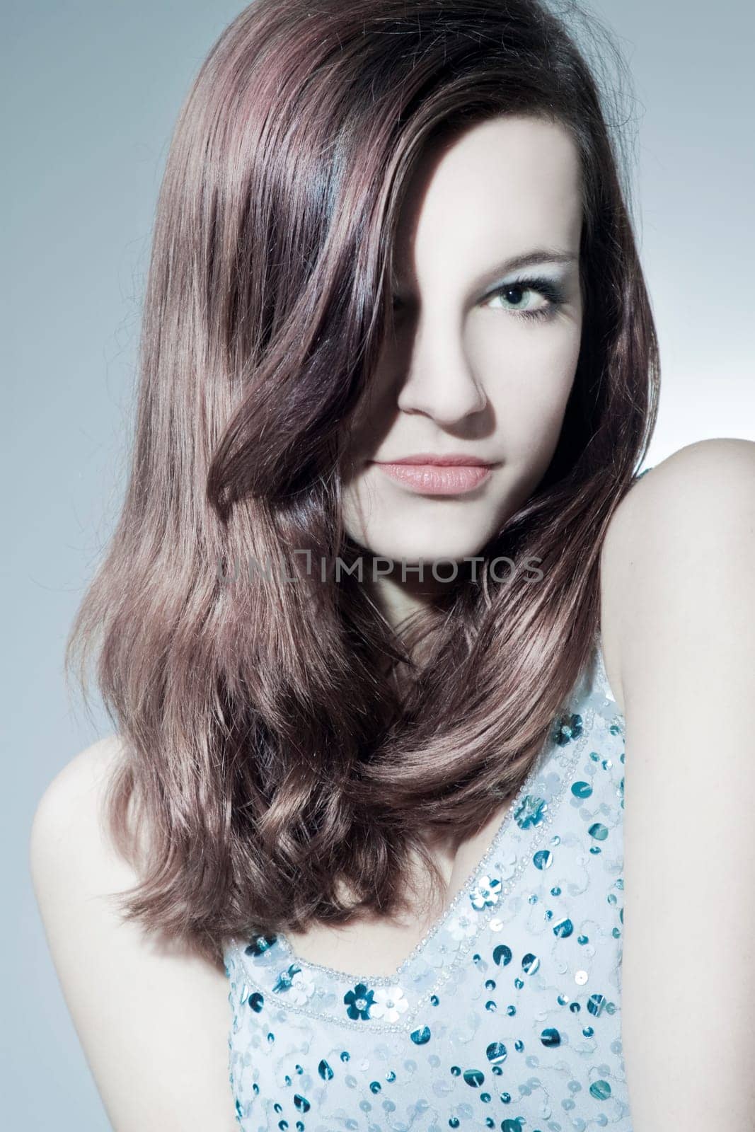 Beautiful young woman with healthy,shiny hair and makeup