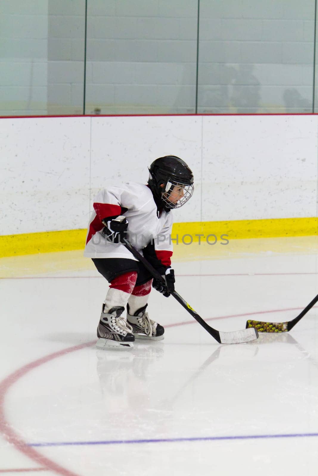 Little boy playing ice hockey
