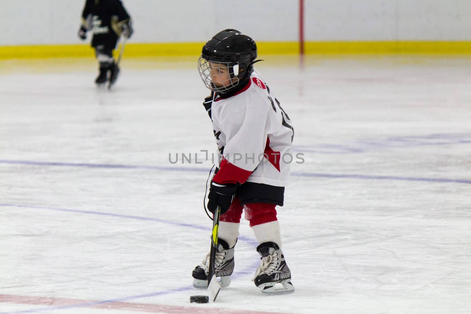 Little boy playing ice hockey