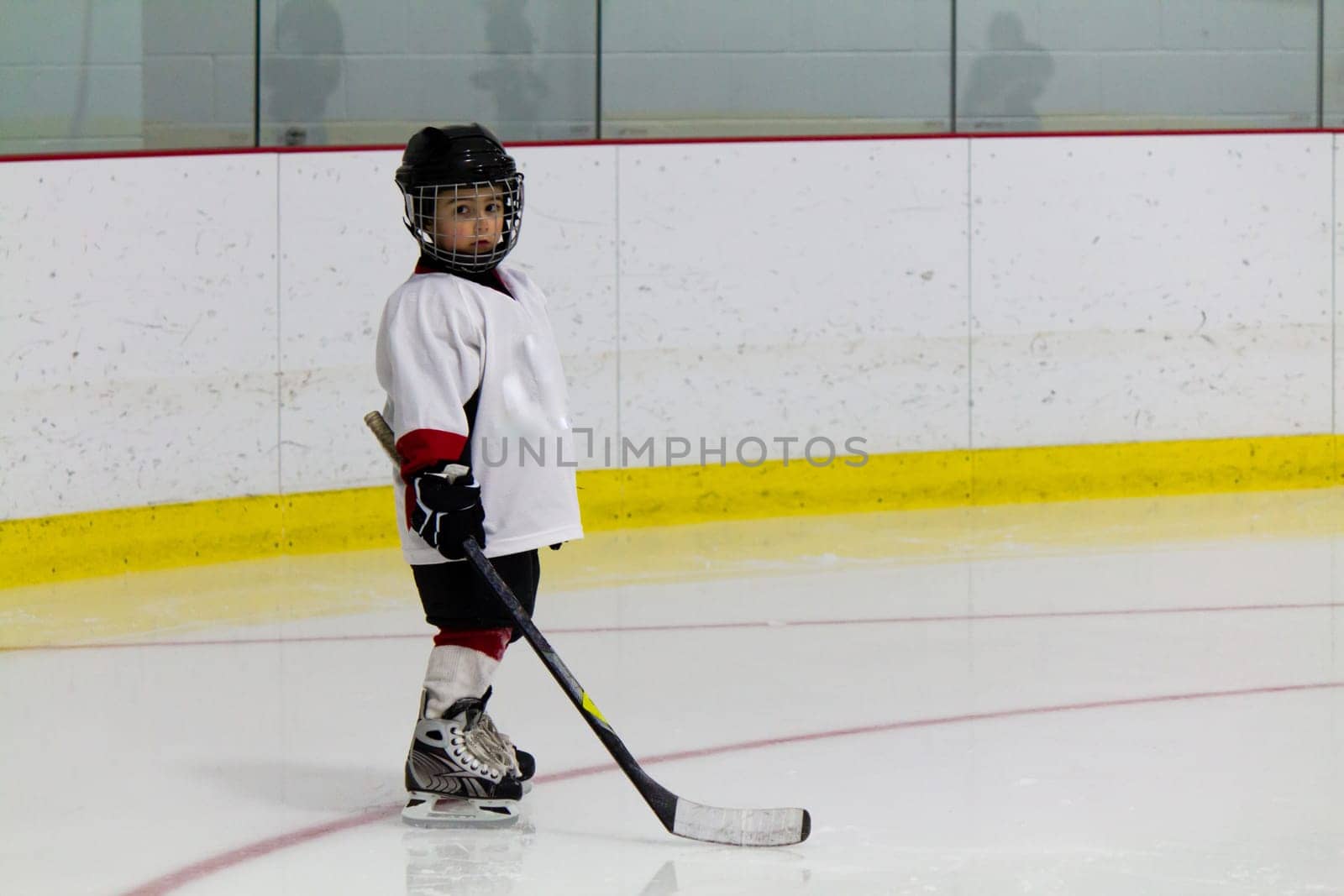 Little boy playing ice hockey