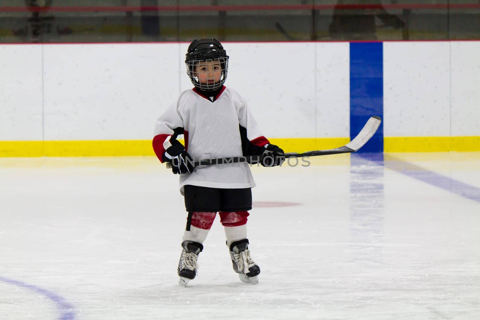 Little boy playing ice hockey