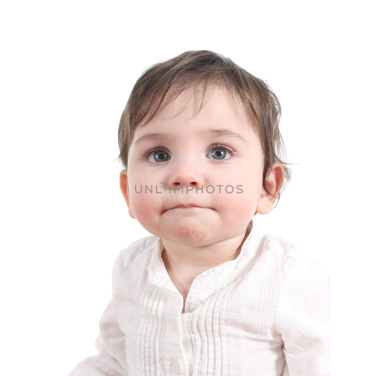 Baby watching attentive with a big blue eyes in a white isolated background