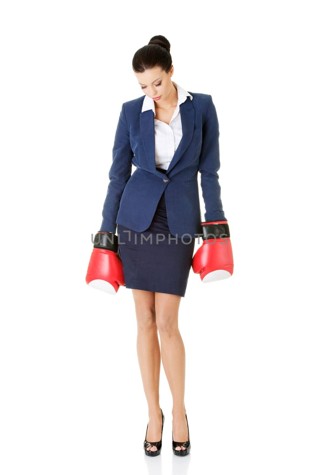 Defeated businesswoman in boxing gloves, isolated on white