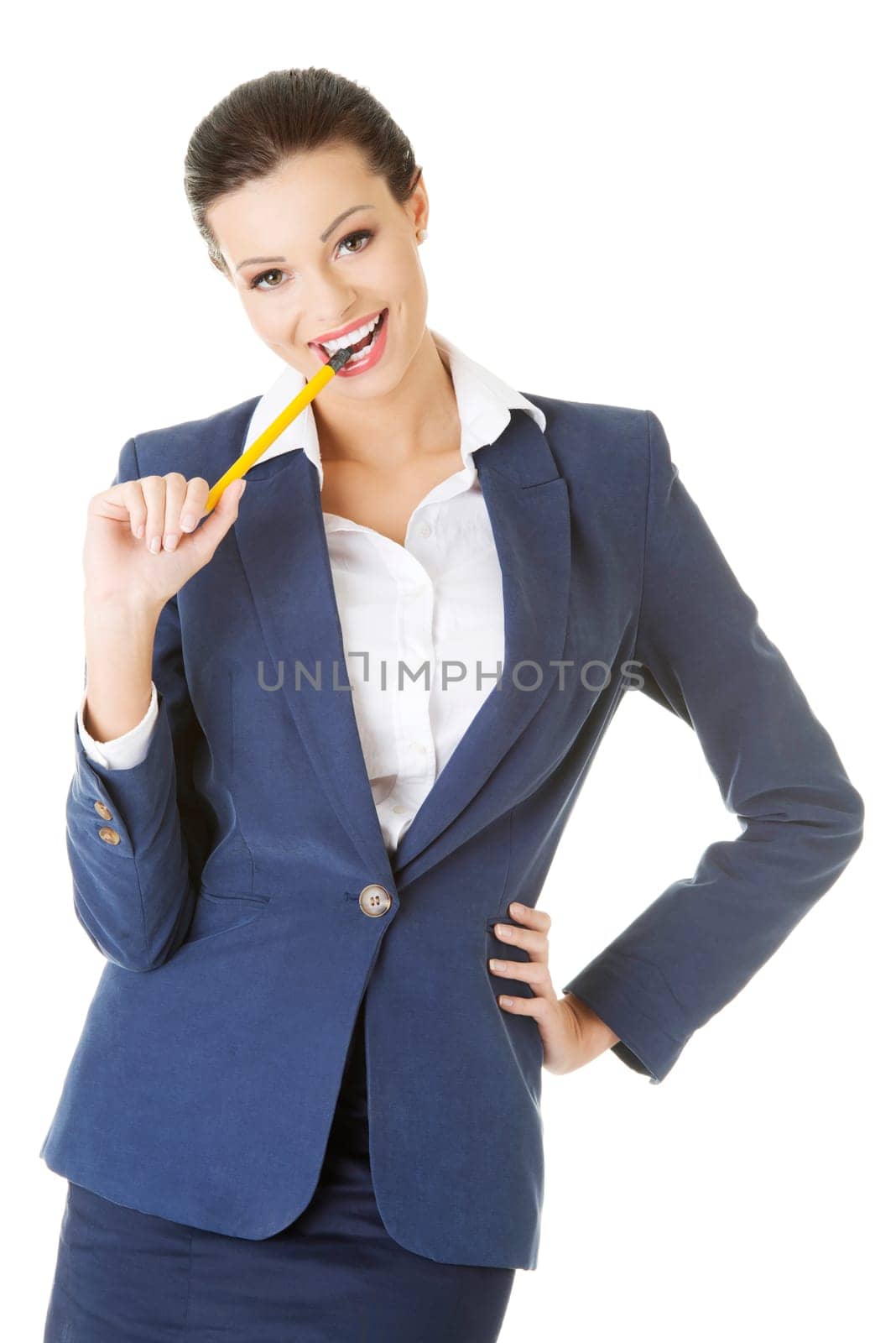 Attractive happy businesswoman with pen in mouth, isolated on white
