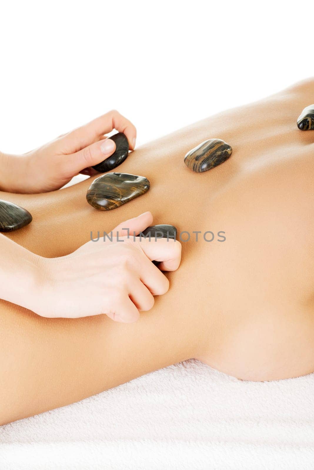 Beauty woman relaxing in spa. Hot stone massage.