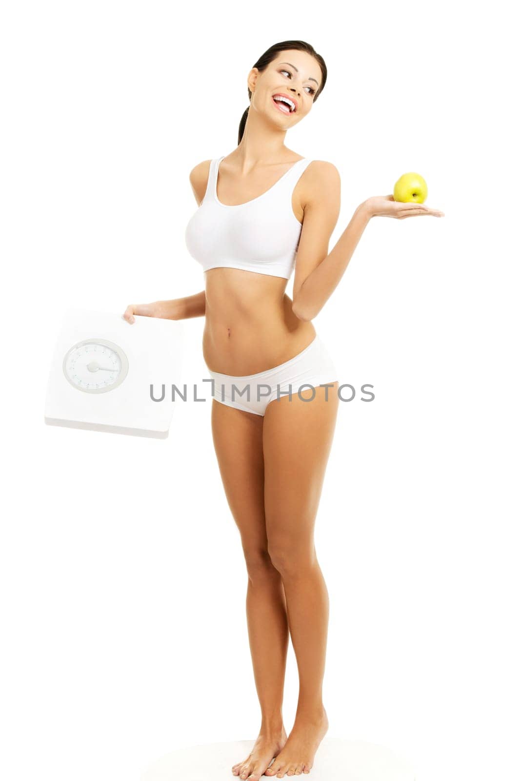 Attractive fit woman with scale and apple, isolated on white
