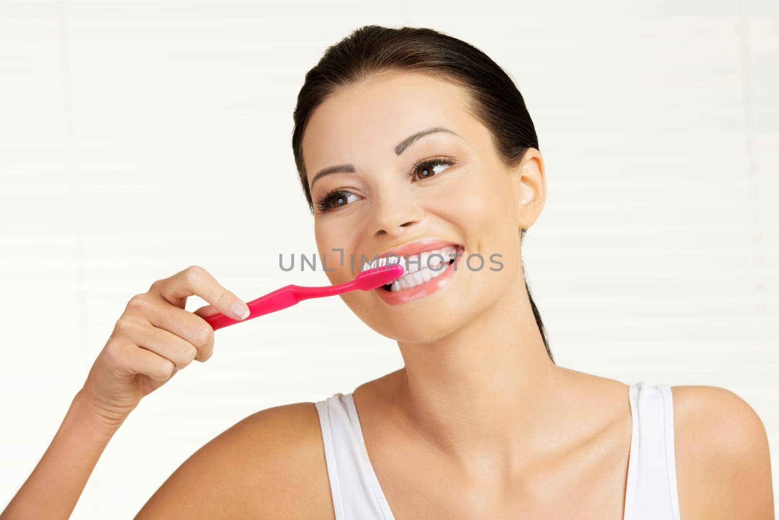 Woman with great teeth holding tooth brush