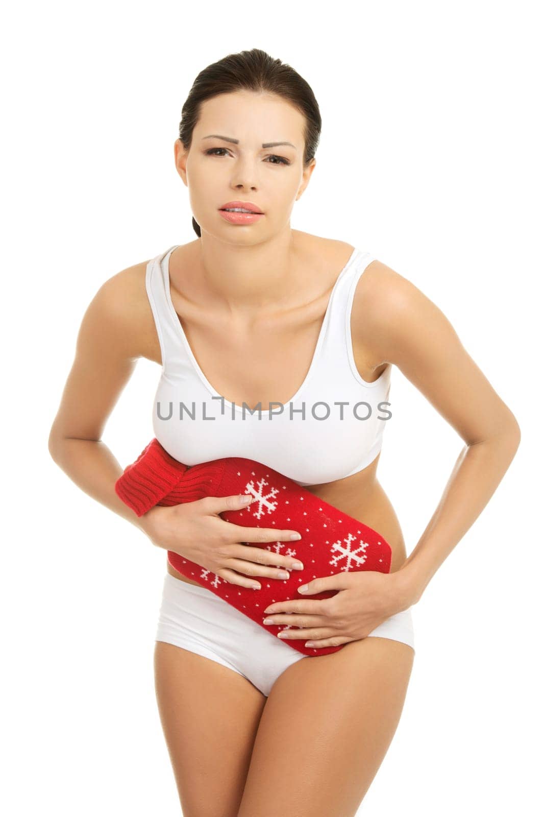 Woman with belly pain holding hot water bottle