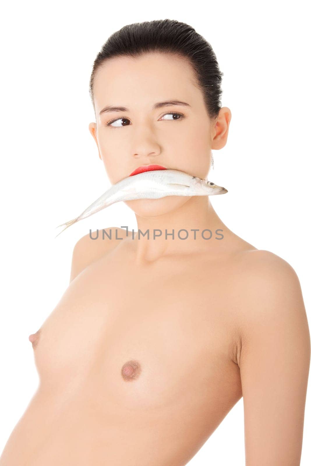 Beautiful young naked woman with fish in her mouth