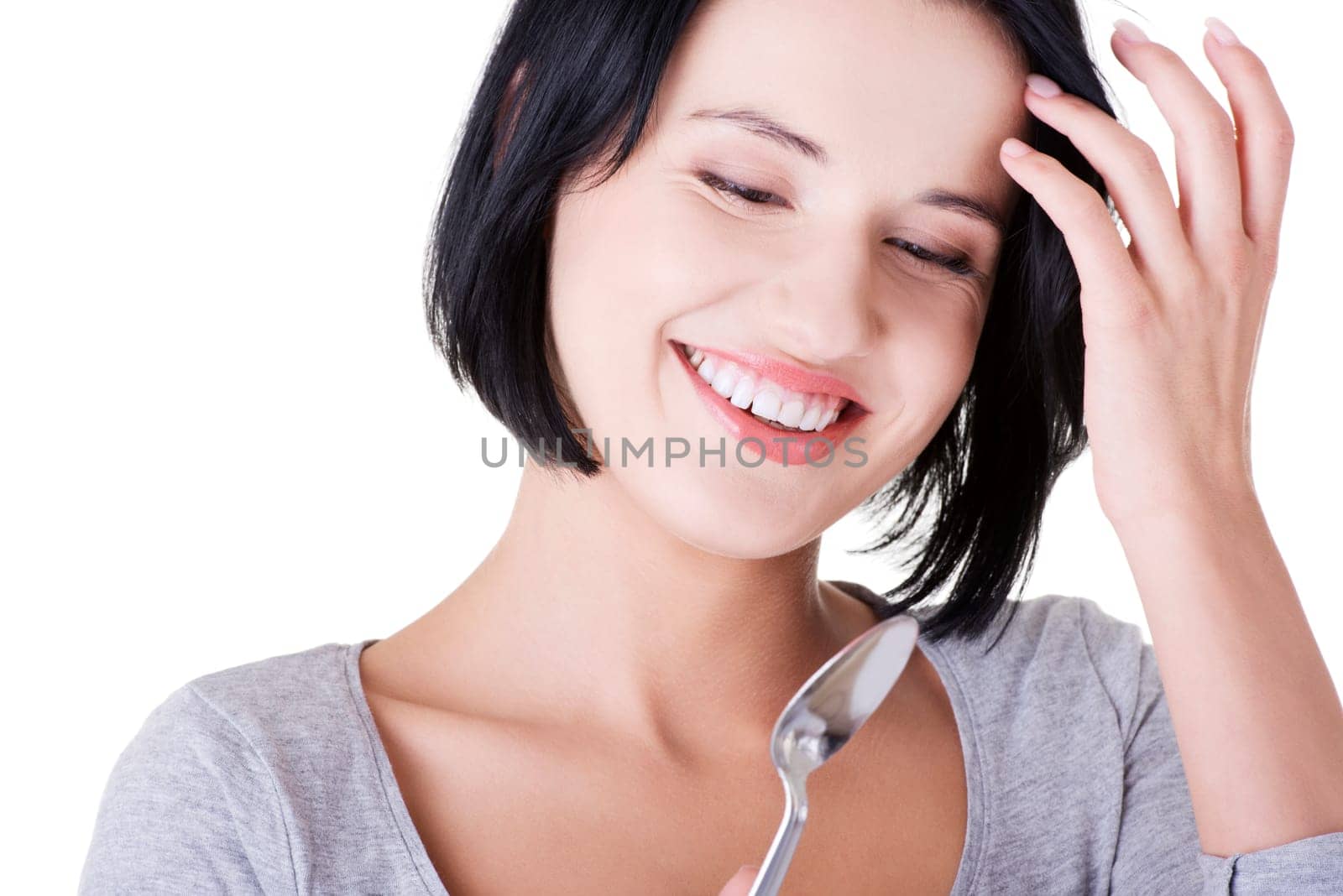Young smiling woman with spoon (pleasure from eating), isolated on white