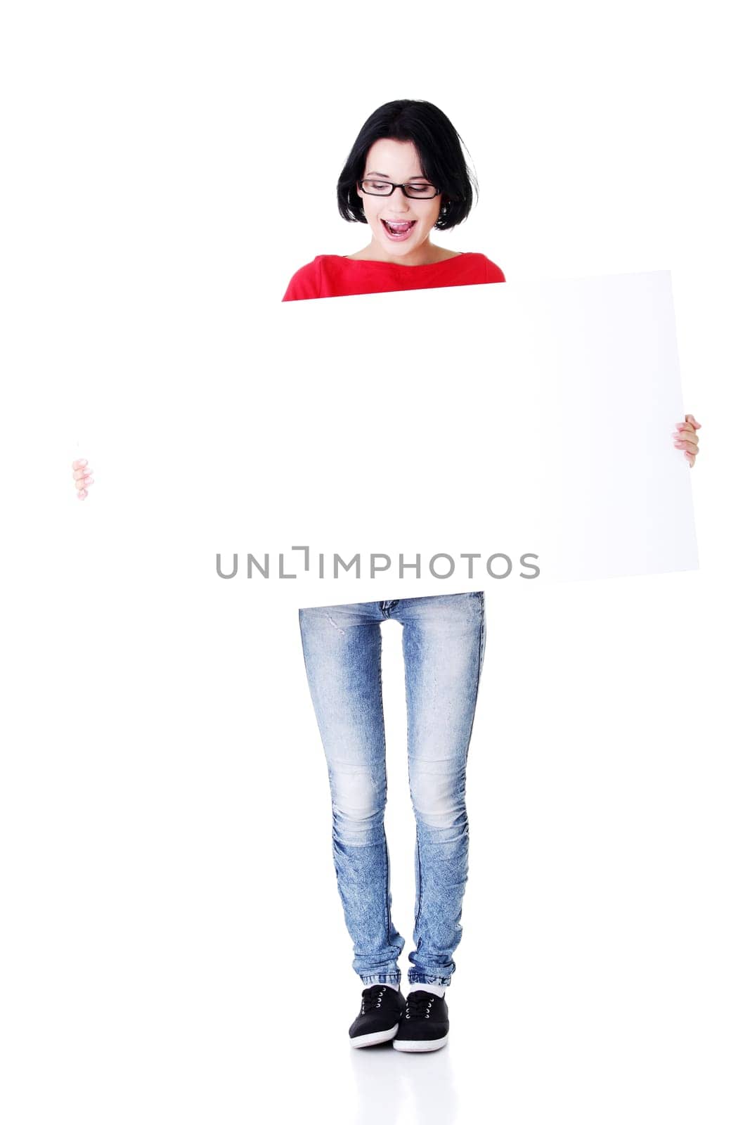Shocked woman holding blank board, isolated on white
