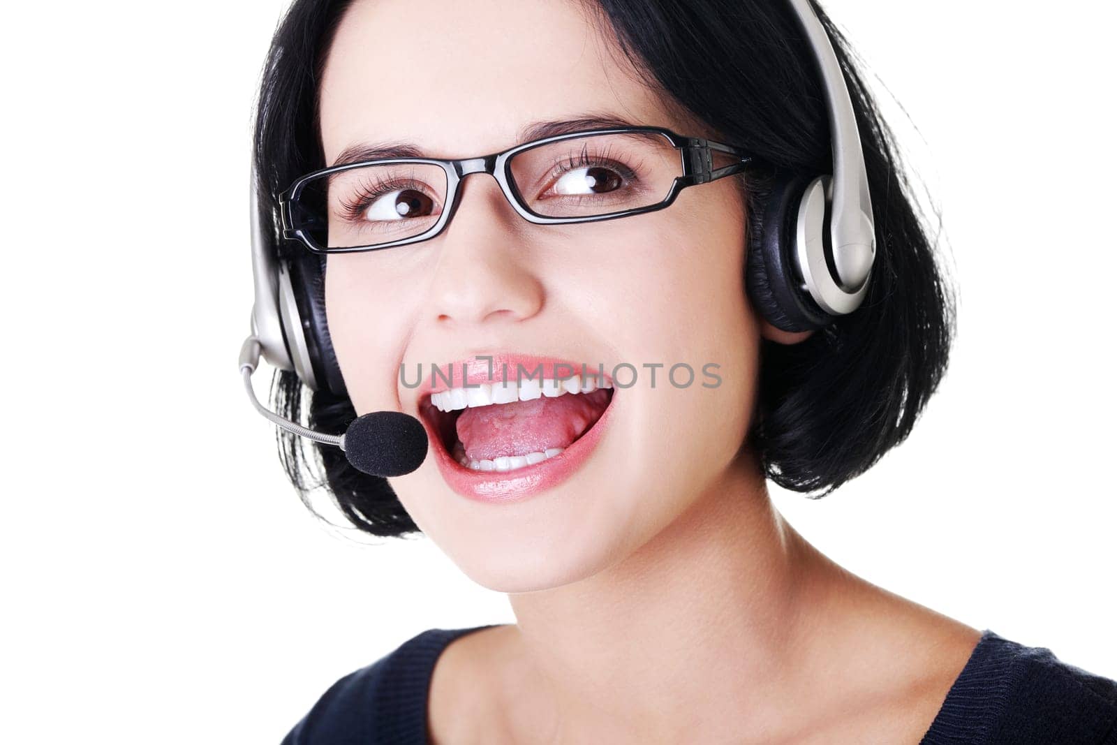 Closeup of attractive customer support representative smiling with headset