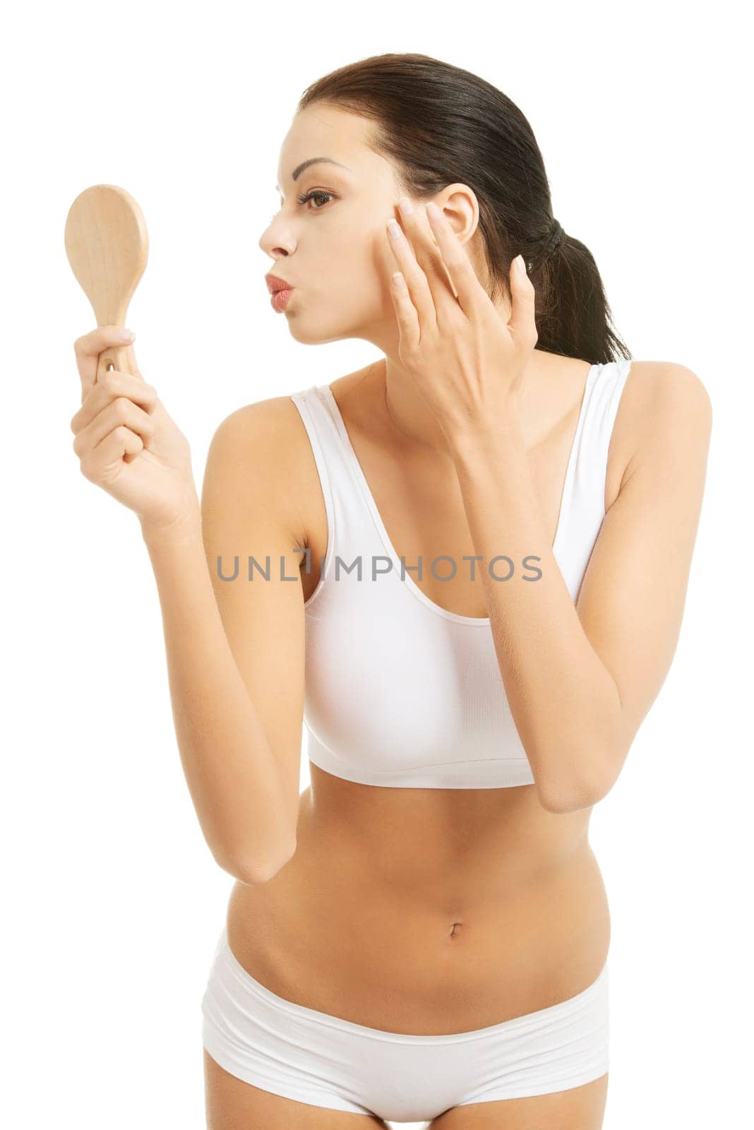 Attractive woman with handy mirror, isolated on white