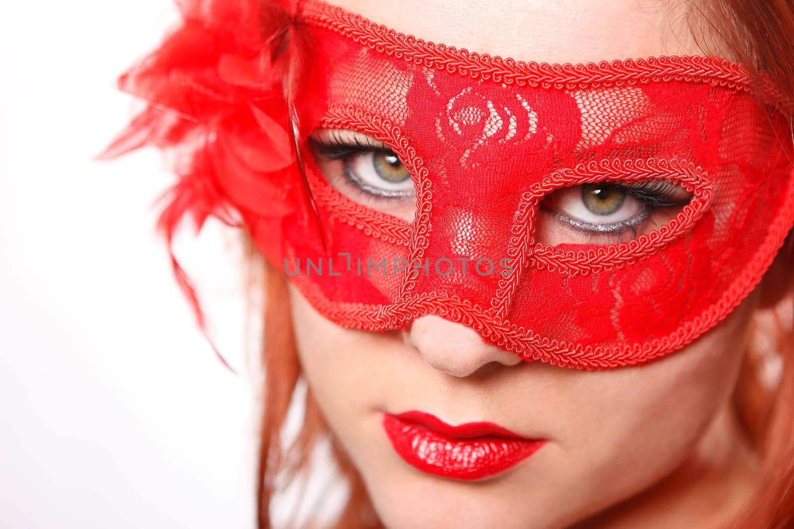 Young woman with red carnival mask