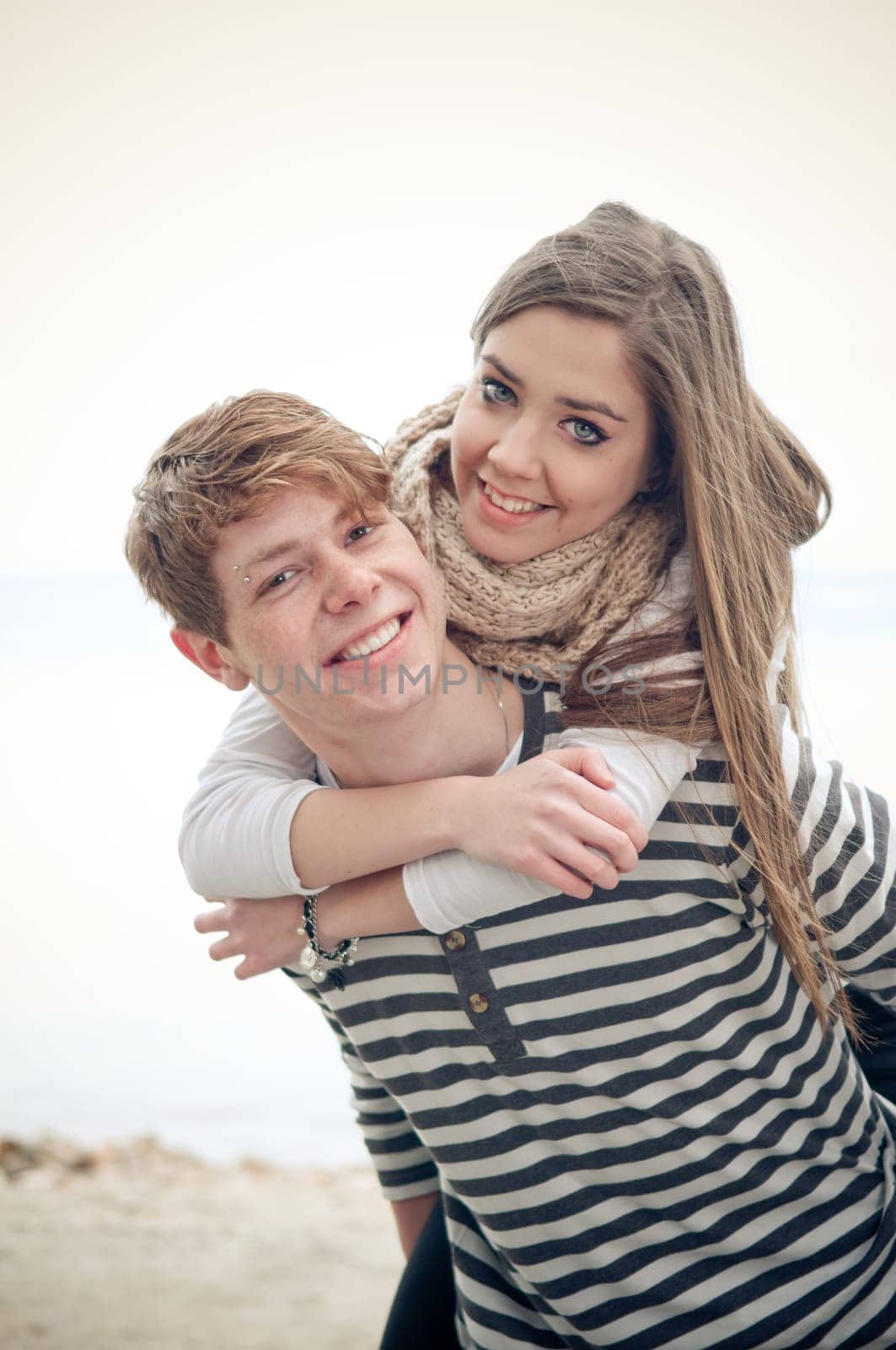 Teenage girl getting a piggyback from her boyfriend