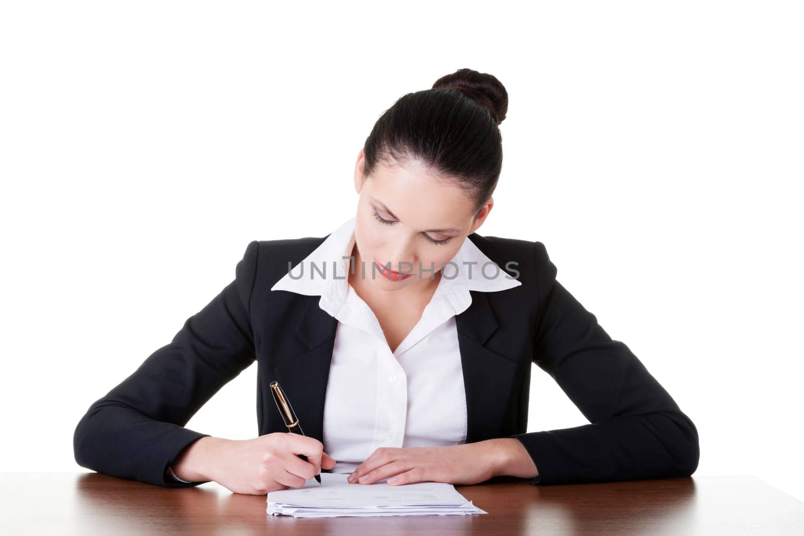Beautiful attractive corporate lawyer business woman sitting at desk and writing blank paper page, isolated on white background.