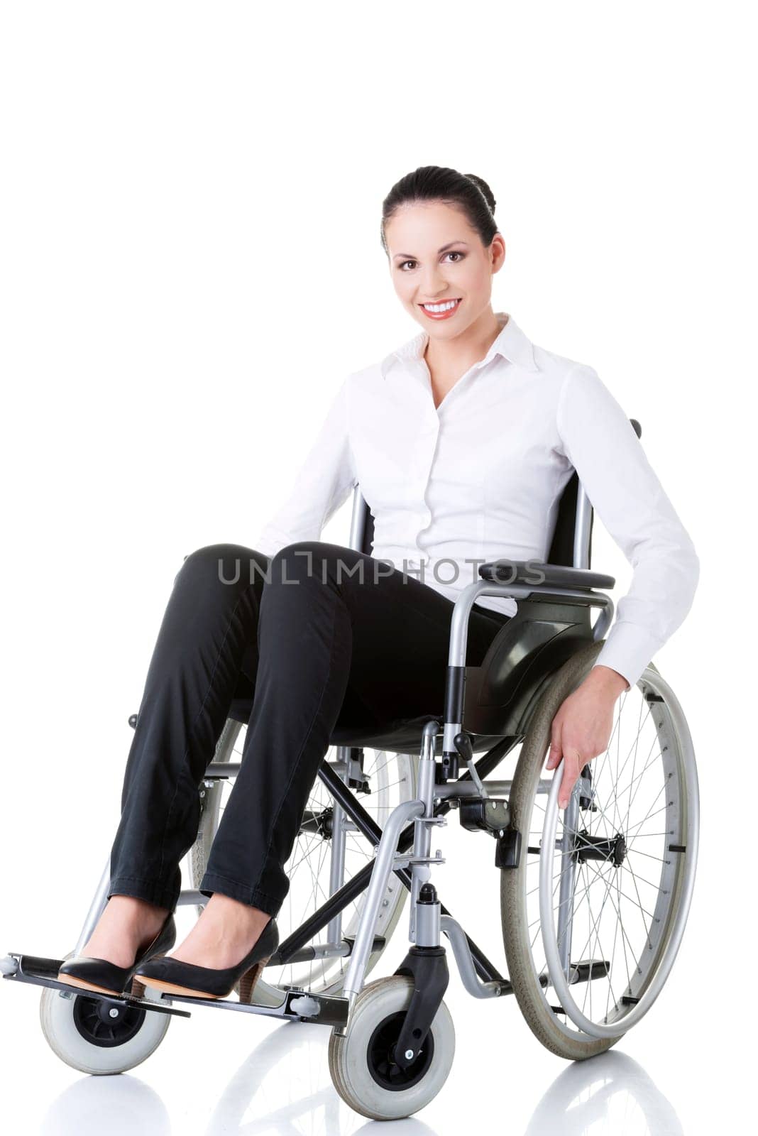Attractive smiling disabled businesswoman sitting in a wheel chair isolated on white