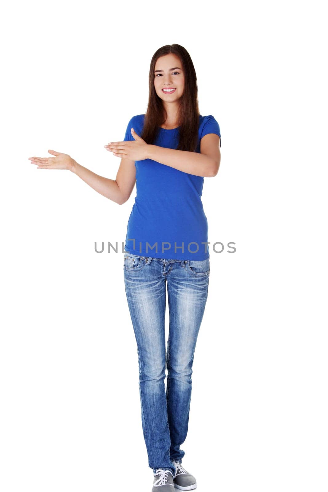 Happy , excited young woman pointing on copy space, isolated on white
