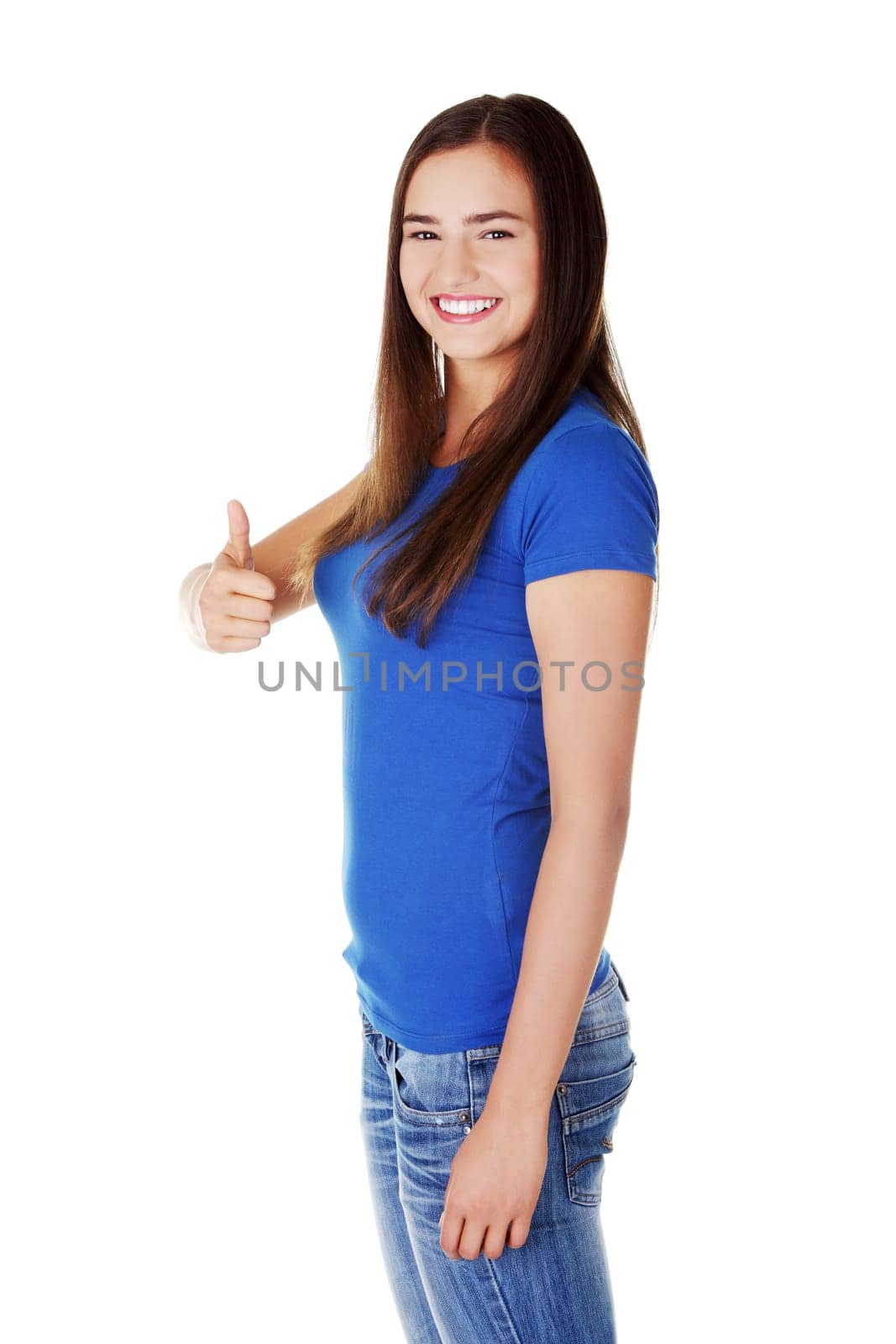 Young student woman gesturing OK , isolated on white.