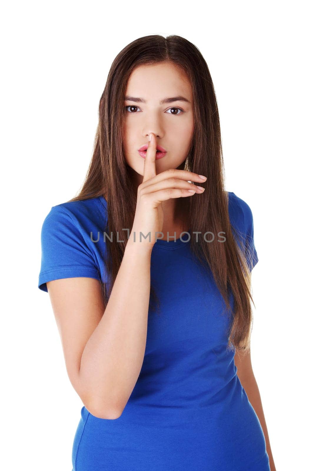 Hush be quiet woman isolated. Teen girl with finger on her lips.