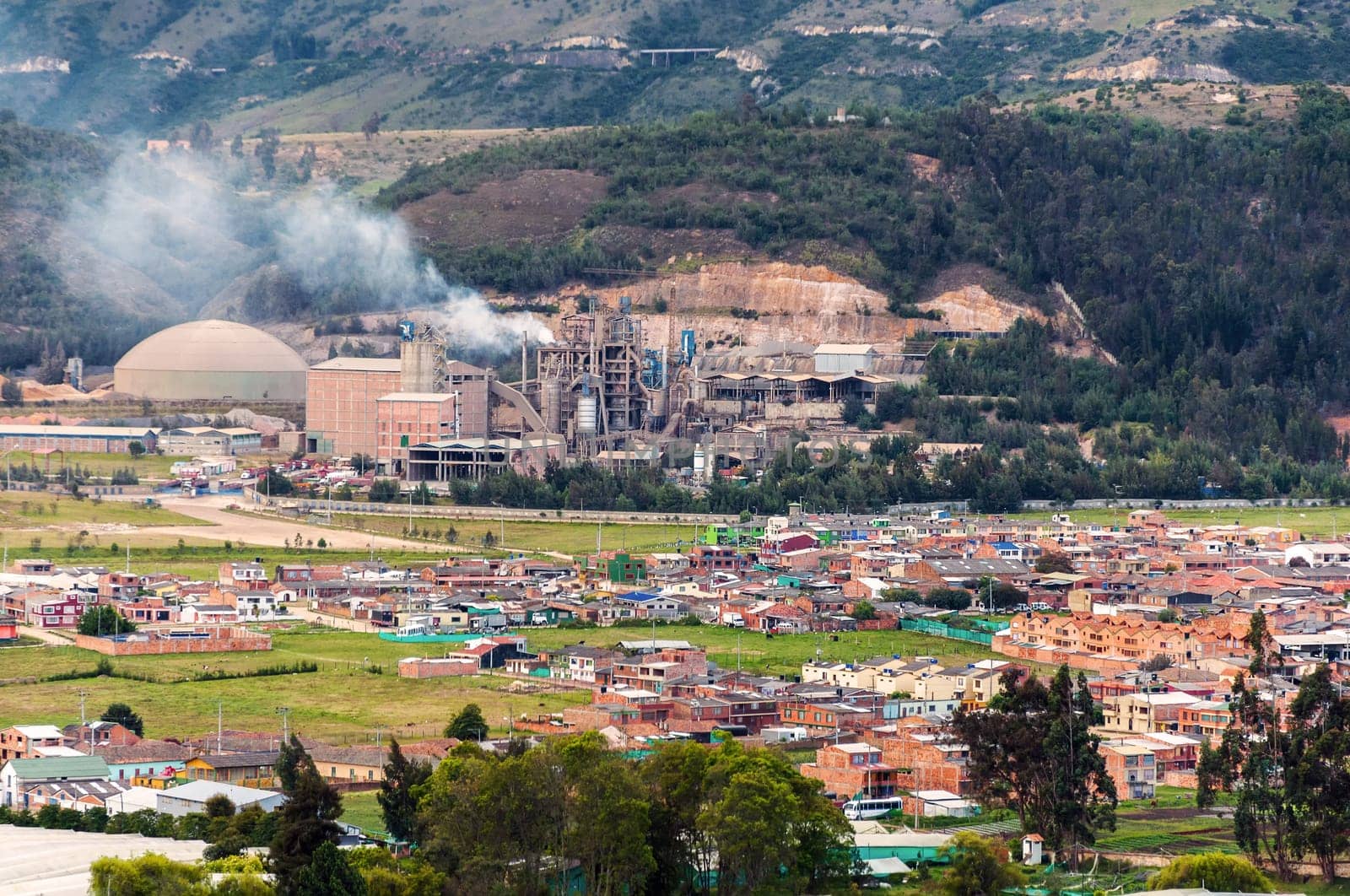A polluting factory with a small town around it