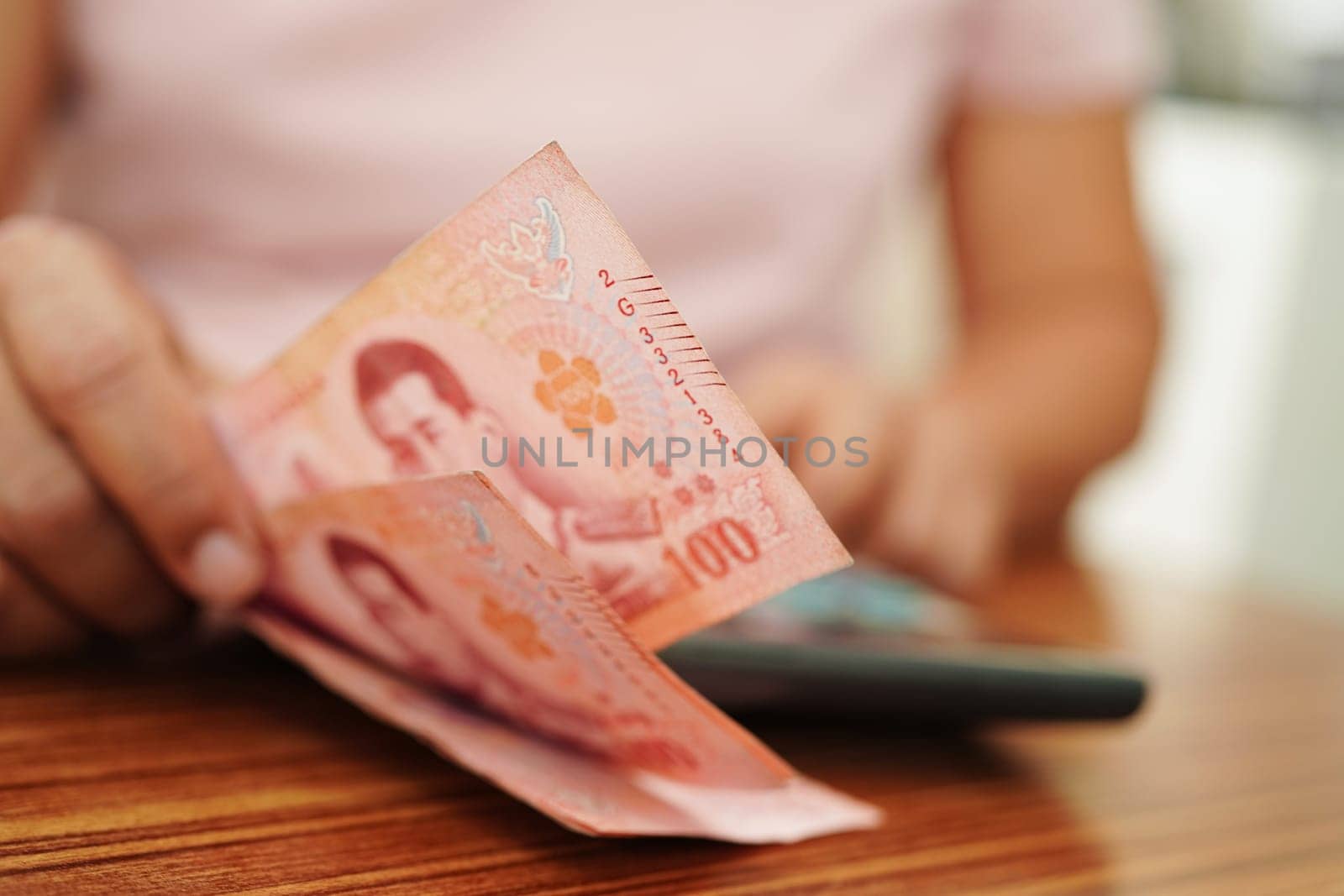 Asian woman counting Thai baht banknote money and holding in hand, investment economy, accounting business and banking.