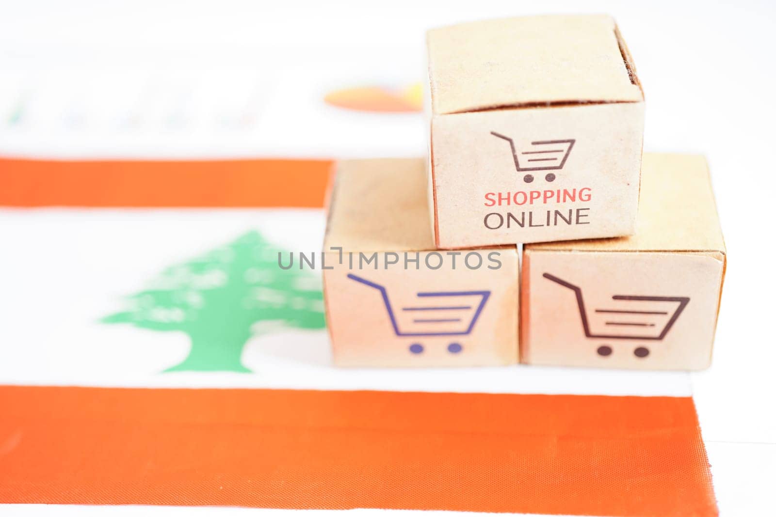 Online shopping, Shopping cart box on Lebanon flag, import export, finance commerce. by sweettomato