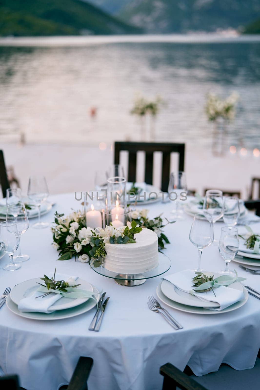 Wedding cake stands on a stand on a festive table set. High quality photo