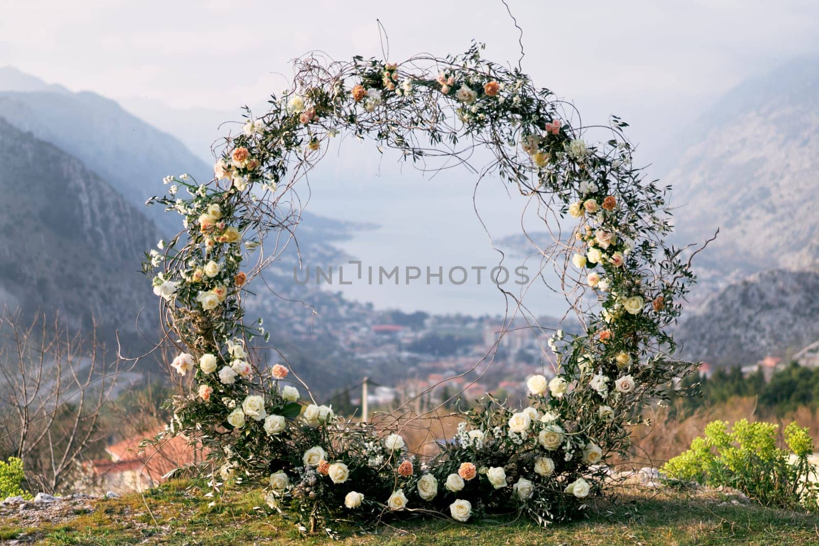 Round wedding arch stands on a mountain on the Bay of Kotor in the valley. High quality photo
