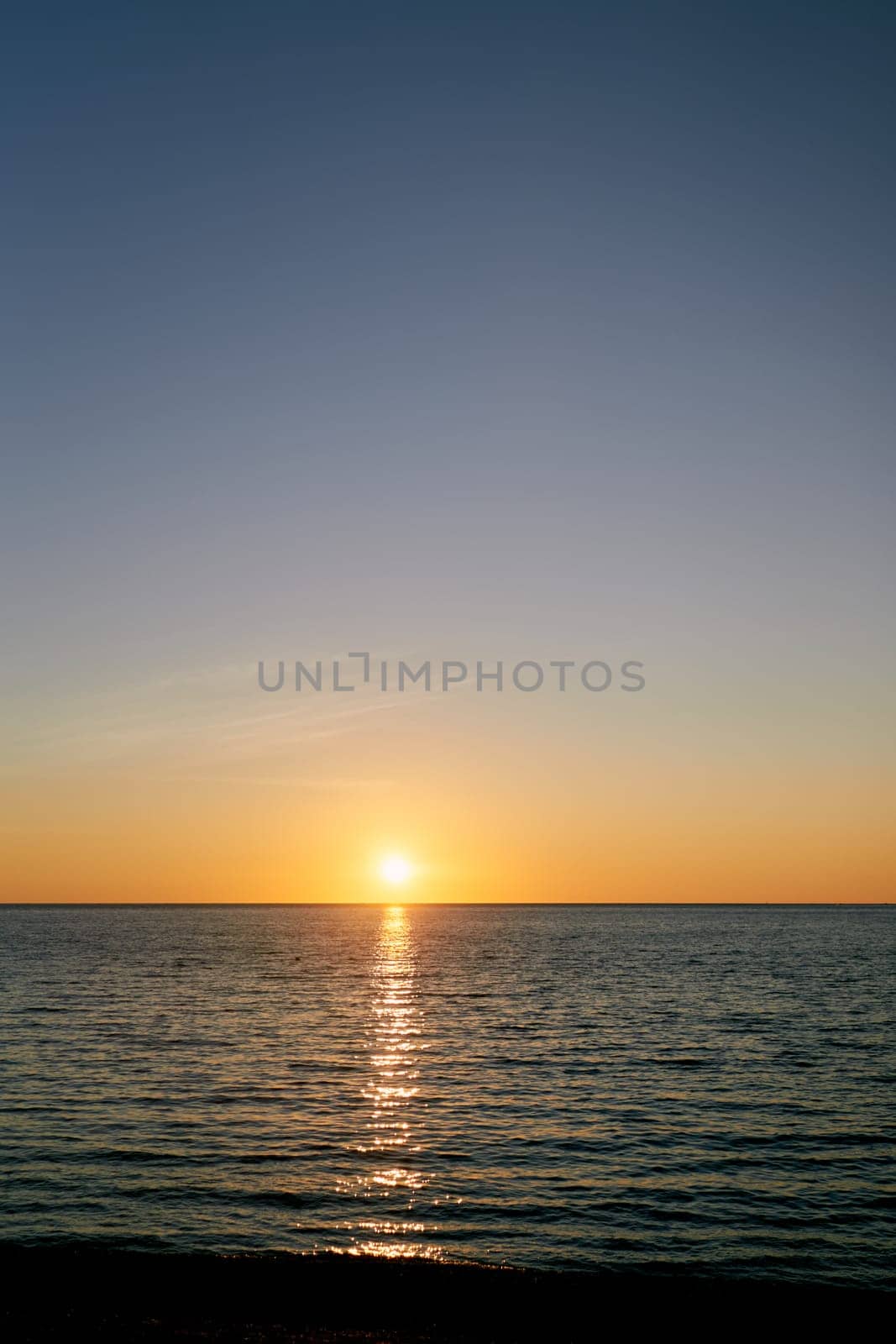 Sunset in the blue sky over the sea. High quality photo