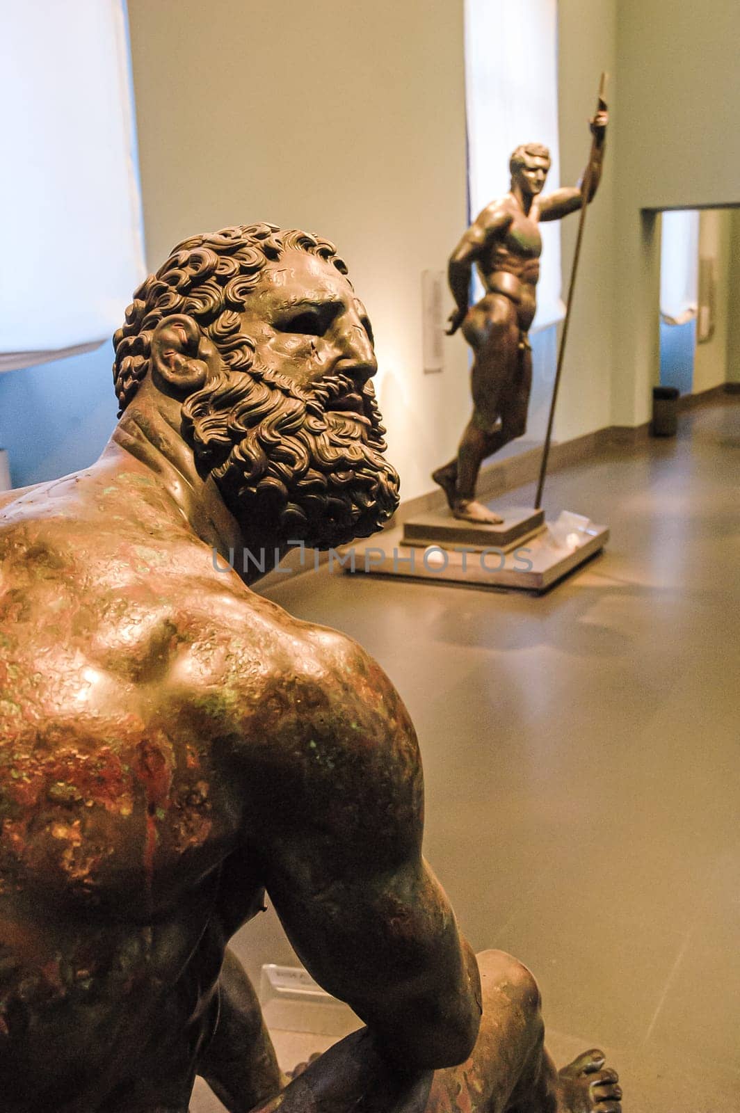Rome, Italy, August 22, 2008: Bronze statue of resting wrestler. Palazzo Massimo. National Roman Museum