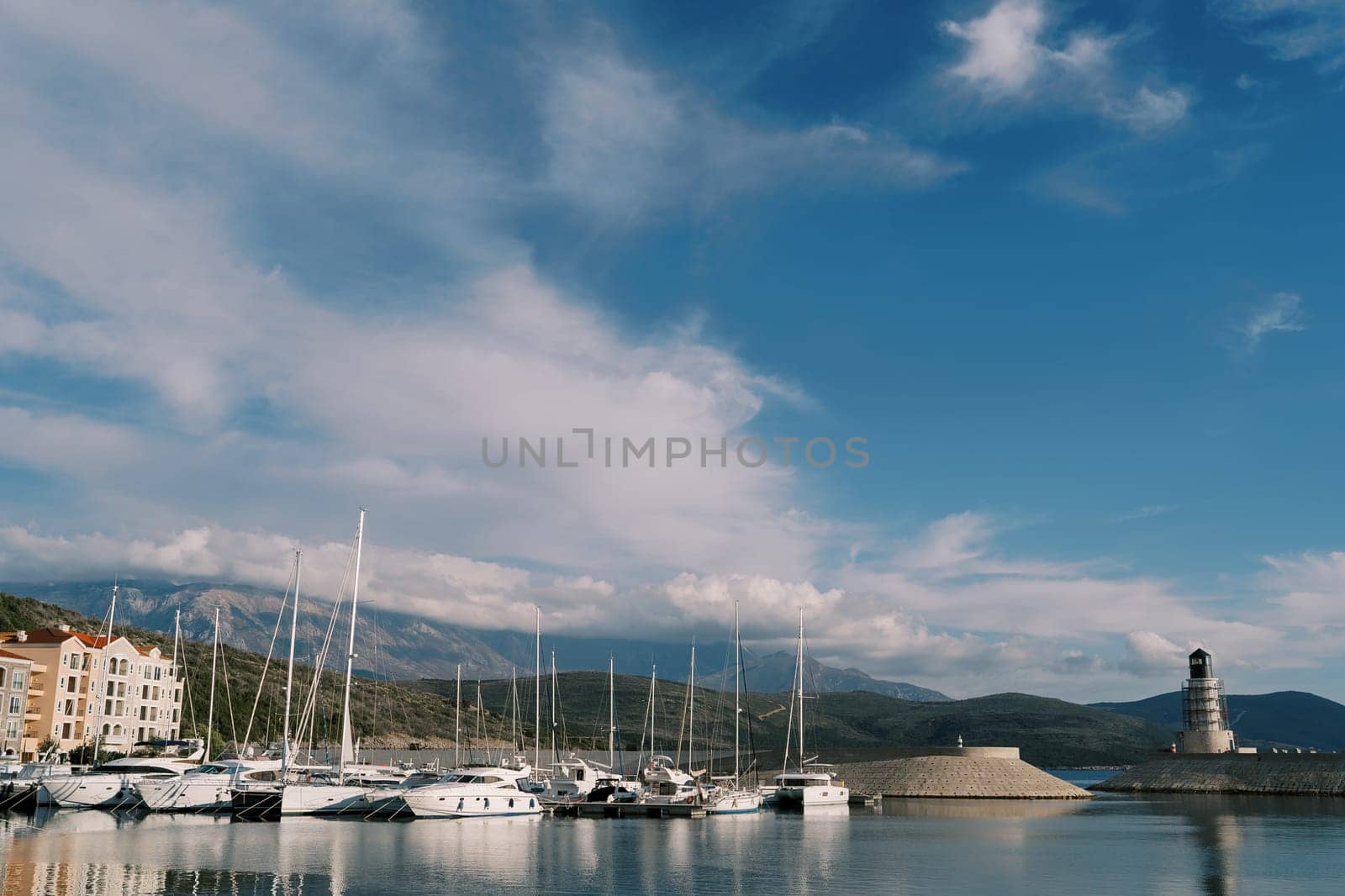 Row of sailing yachts are moored at Lustica Bay near the lighthouse. Montenegro. High quality photo