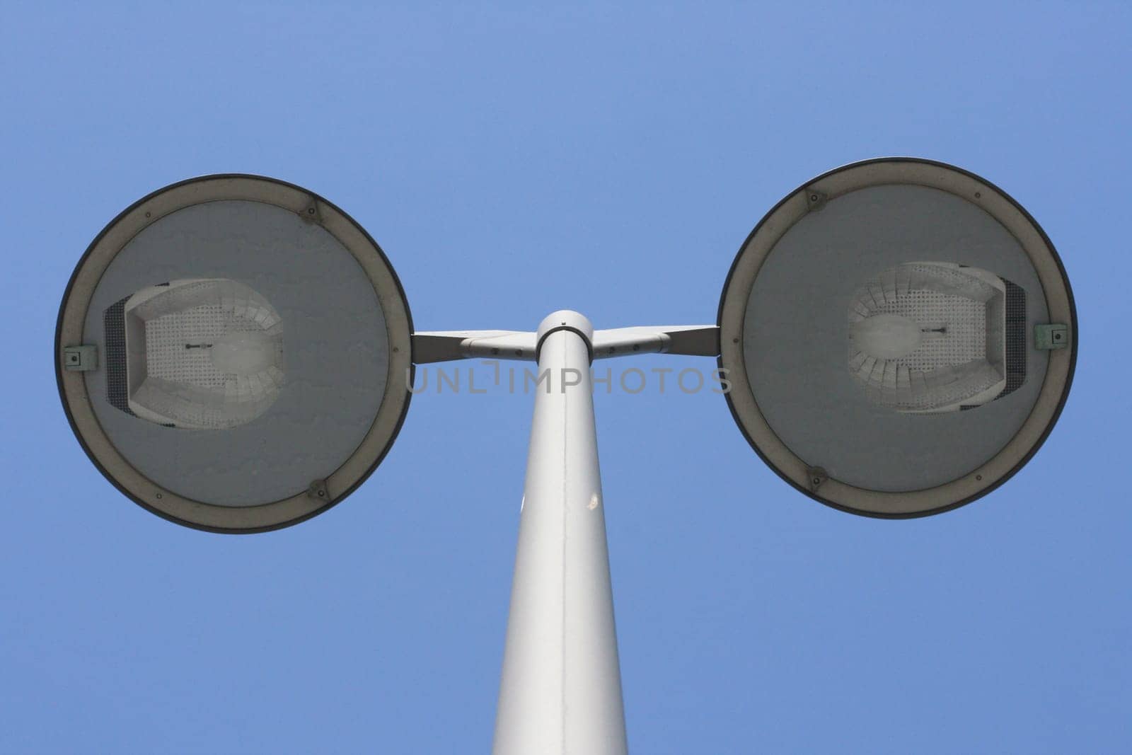Street lamp with two spotlights,blue sky in the background
